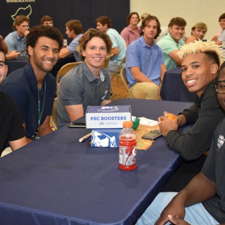 Diverse group of students engaging in college athletics promotion at Pensacola State College.