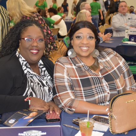 College event attendees celebrating Pensacola State College athletics campaign at Pirate Experience.