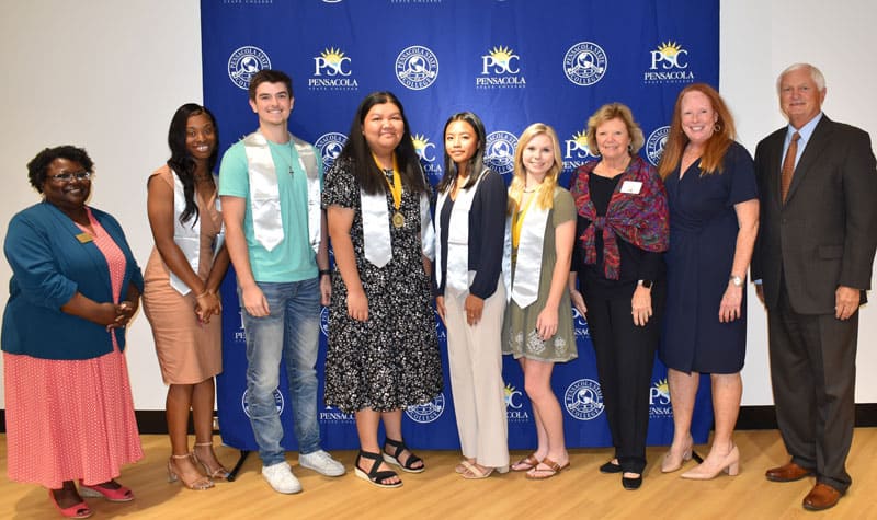 Diverse group of students and faculty celebrating academic achievements and leadership recognition.