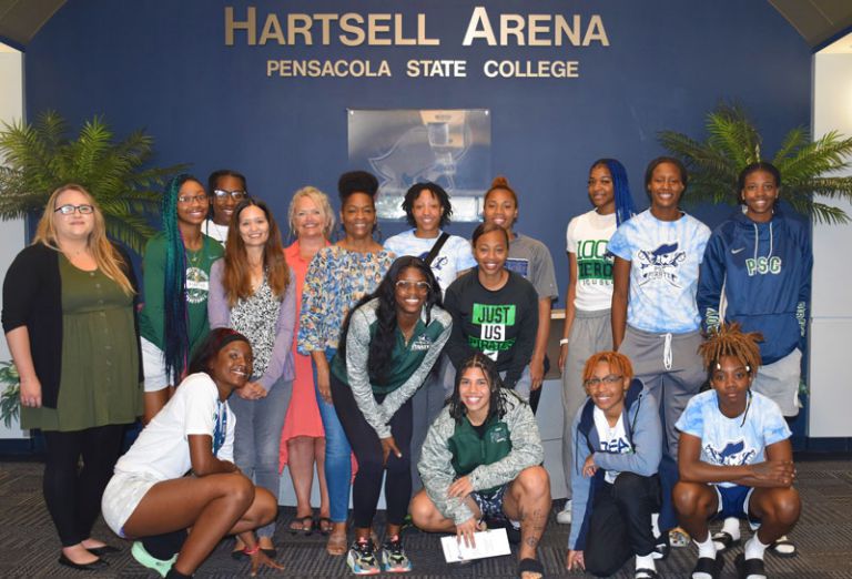 Women&rsquo;s basketball team at Pensacola State College engaged in domestic violence awareness discussion.