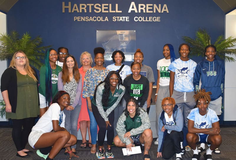 Women&rsquo;s basketball team at Pensacola State College engaged in domestic violence awareness discussion.