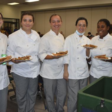 Student chefs participating in Pizza with the President event at Pensacola State College.