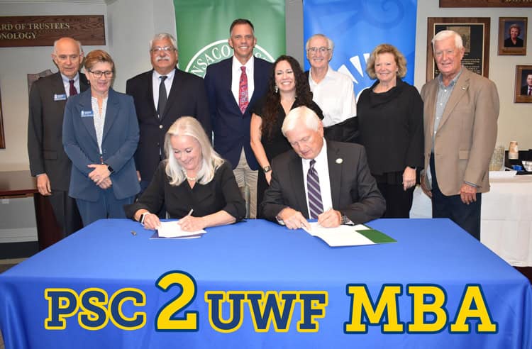 Optimized image showing officials signing BAS to MBA transfer agreement at Pensacola State College.