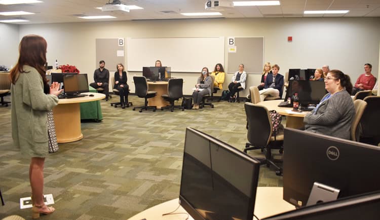 Student presenting at PSC Robinson Honors Program Student Symposium in a classroom setting.