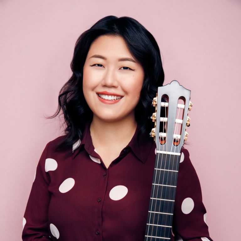 Guitarist Bokyung Byun with guitar at Pensacola State College concert.