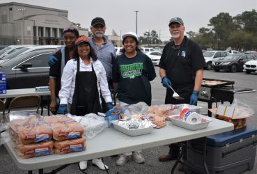 Nursing students and faculty preparing food for Homecoming celebration at Pensacola State College.