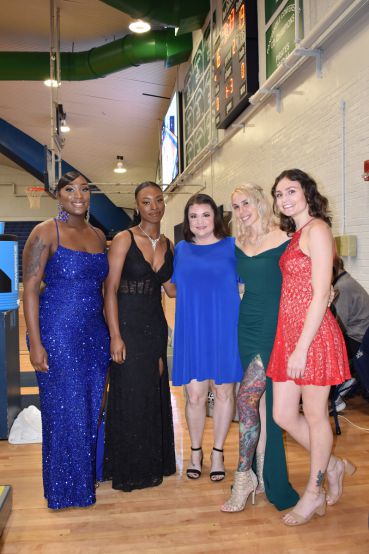 Diverse group of students dressed in formal attire at Pensacola State College Homecoming event.