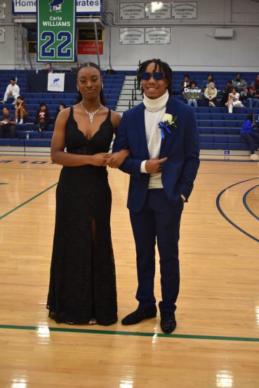 PSC nursing students crowned 2023 Homecoming Queen and King at a basketball game.