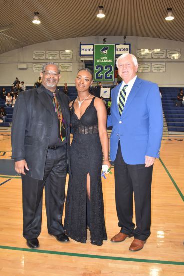 Celebrating PSC nursing students crowned 2023 Homecoming Queen and King in a school gymnasium.