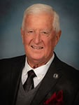 Portrait of a Board of Trustees member at Pensacola State College, highlighting leadership in higher.