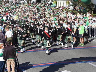 Vibrant parade scene showcasing participants in traditional Scottish kilts during Pensacola State Co.