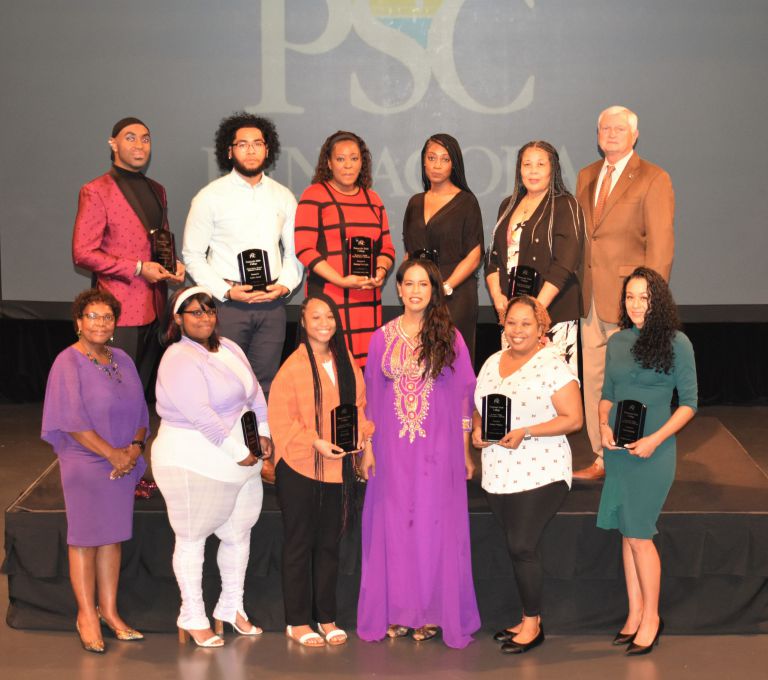 Diverse group of students and supporters celebrating scholarship achievements.