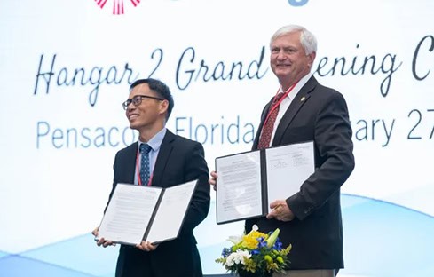 University officials sign aviation maintenance training partnership with ST Engineering at Pensacola.