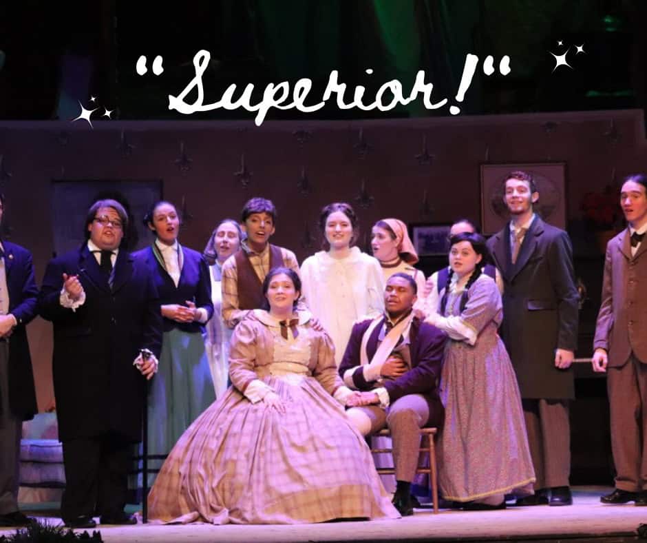 Ensemble of students in period costumes portraying characters from the classic play.