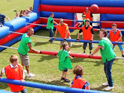 Vibrant human foosball game with children and adults playing at Pirate Fest 2023 event.