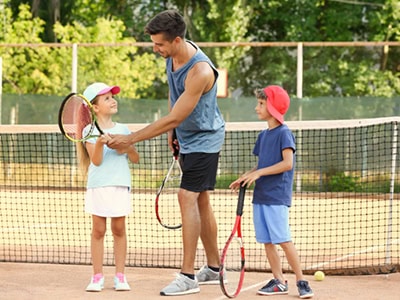 Engaging children in tennis and pickleball clinics at Pensacola State College sports facilities.