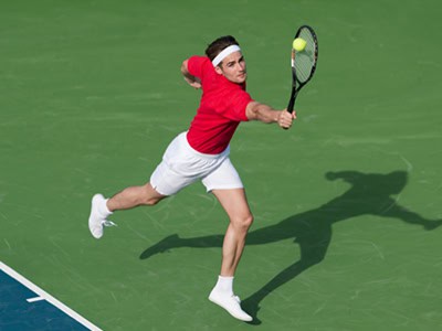 Tennis player hitting a ball during a college tennis clinic at Pensacola State College.