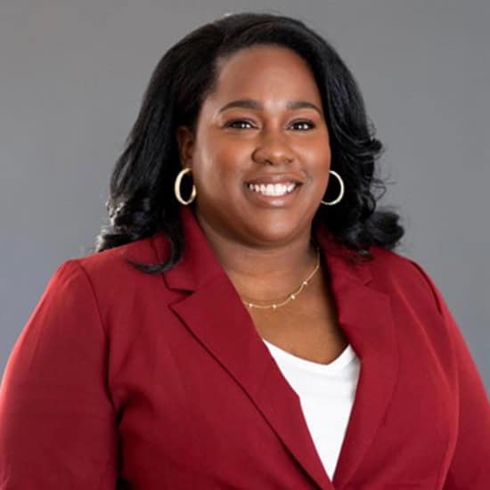 Diverse student smiling, promoting Pirates Care support services at Pensacola State College.