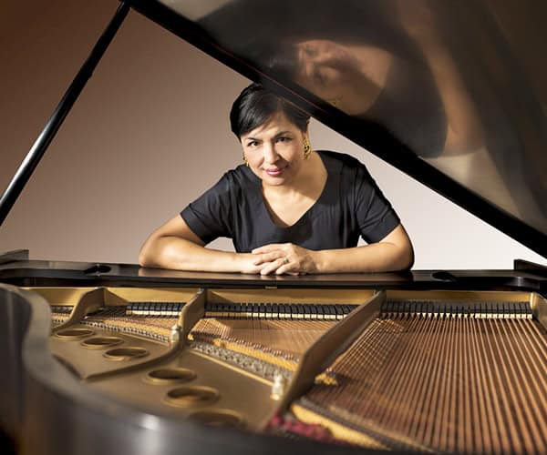Elegant female pianist performing at Pensacola ComposerFest XVIII event.