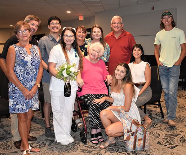 Nursing students and family members celebrating at Pensacola State College graduation ceremony.