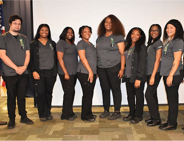 High school graduates in the Medical Assisting Program receiving pins at a graduation event.