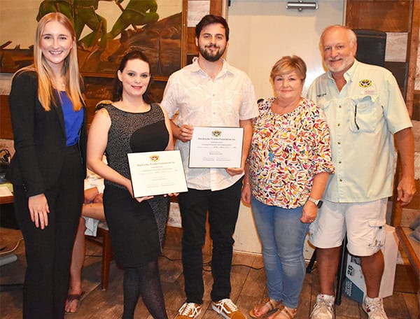 Scholars receiving certificates for local history preservation at Pensacola State College event.