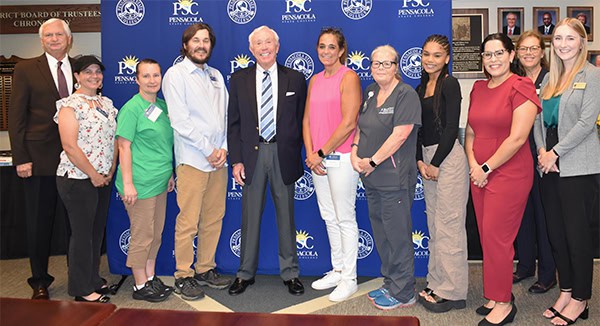 Students and officials celebrating scholarship awards at Pensacola State College.