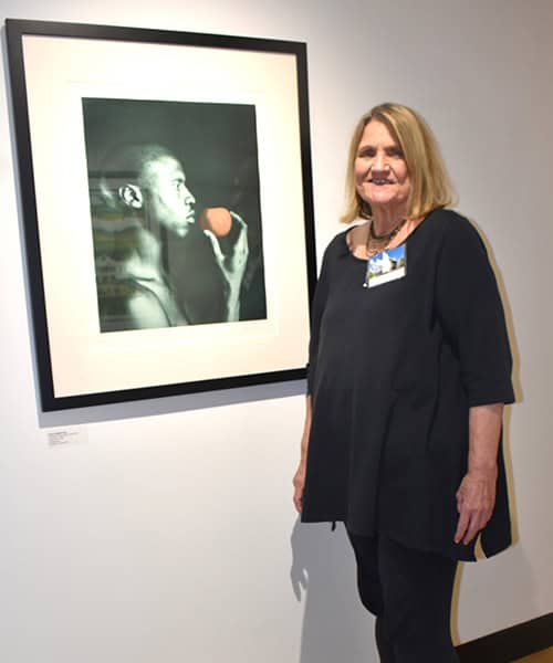Supporter honored for artwork donation at PSC art exhibit.