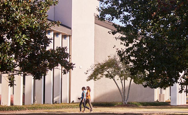 Students walking on campus during a guided tour at Pensacola State College.