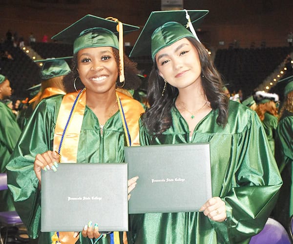 Graduates celebrating at Pensacola State fall graduation event.