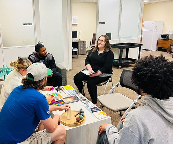 Diverse students participate in an engaging college workshop at Pensacola State College.