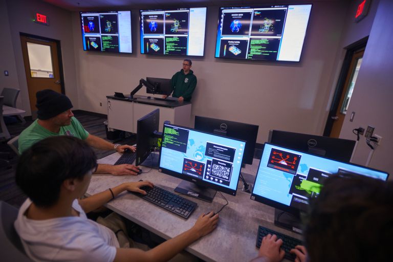 Cybersecurity students engaging in advanced cyber defense exercises at Pensacola State College.
