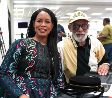 Diverse group celebrating Black History Month at Pensacola State College event.