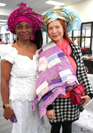 Diverse women wearing vibrant traditional and modern clothing during Black History Month event at Pe.