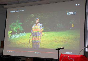 Diverse African heritage woman in traditional attire during Black History Month event at Pensacola S.