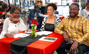 Diverse group of students and faculty honoring Black History Month with cultural celebration.