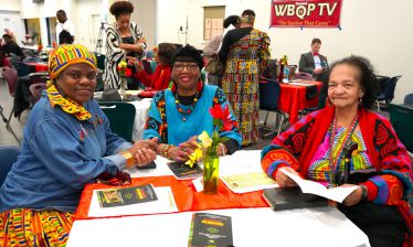 Diverse group of individuals participating in Black History Month event at Pensacola State College.