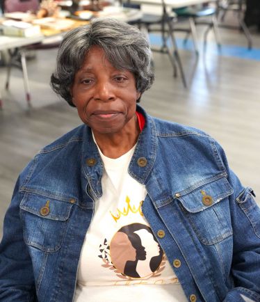 Diverse woman wearing a denim jacket and T-shirt with Black history design.