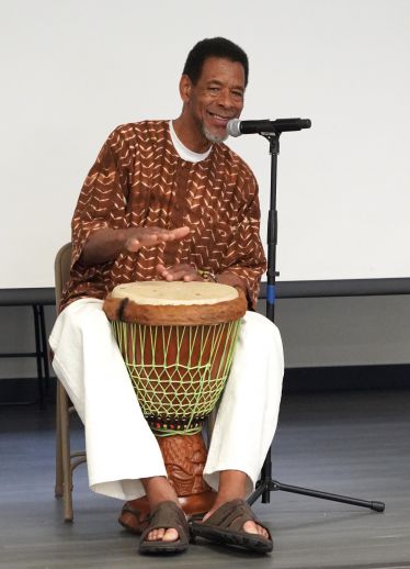 African American musician playing djembe drum during Black History Month event at Pensacola State Co.