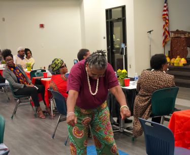 Diverse group of people enjoying Black History Month event at Pensacola State College.
