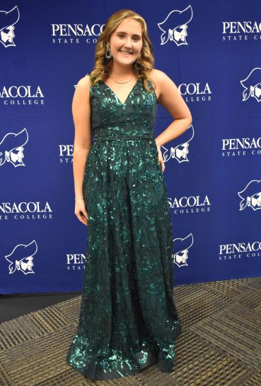 Graduation celebration featuring a young woman in a green sequined gown at Pensacola State College.