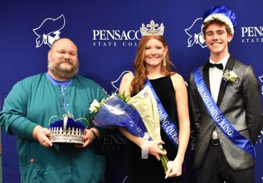 Pensacola State College homecoming event with crowned king and queen, students celebrating.
