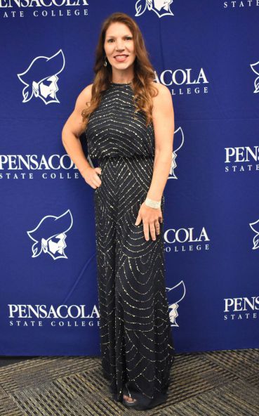 Woman in black evening gown with silver embellishments at Pensacola State College.