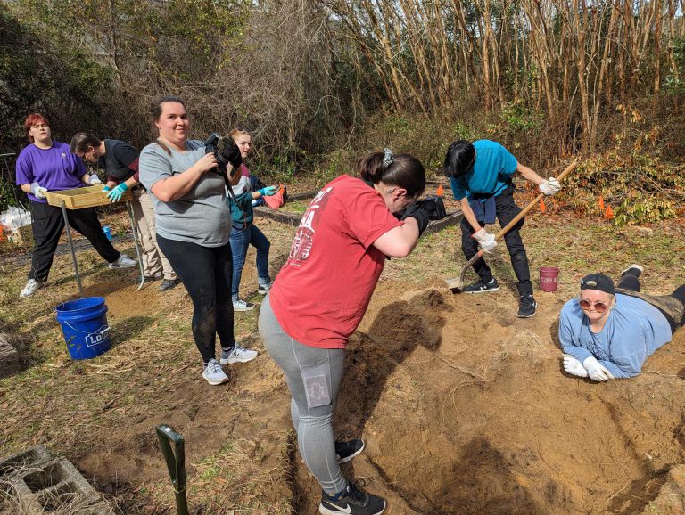 Crime Scene Technician students examine and excavate carcass during annual pig dig at Pensacola Stat.