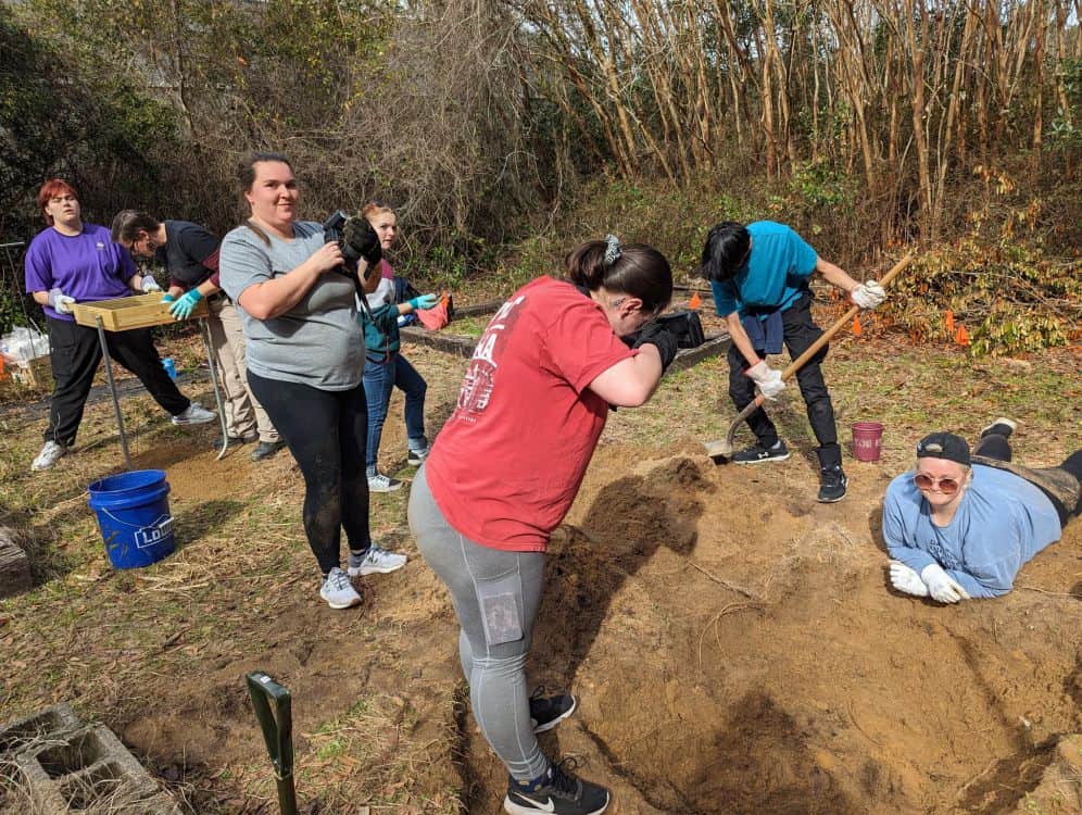 Crime Scene Technician students examine and excavate carcass during annual pig dig at Pensacola Stat.