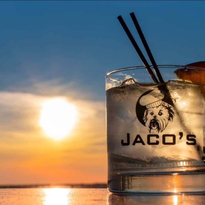 Sunset view with cocktail featuring Jaco's logo at Pensacola State College sunset photography contes.