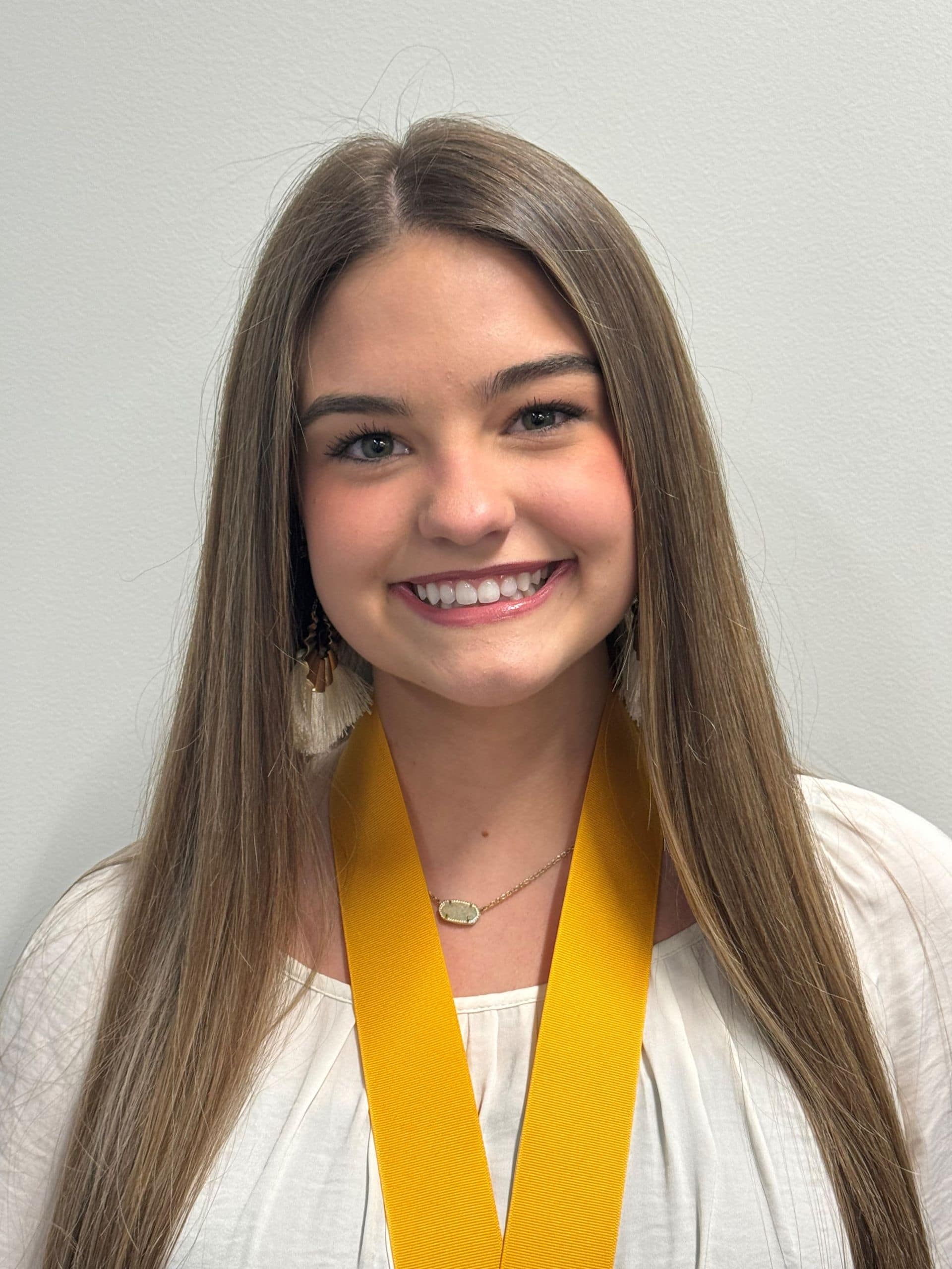 Honors student with medal at Pensacola State College honors reception.
