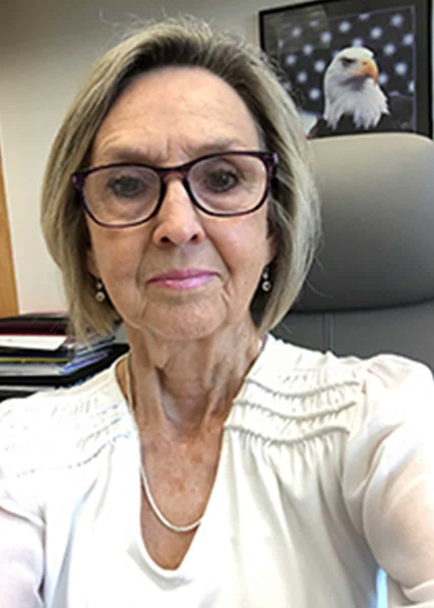 Accessible image of a professional woman in an office setting, promoting higher education opportunit.