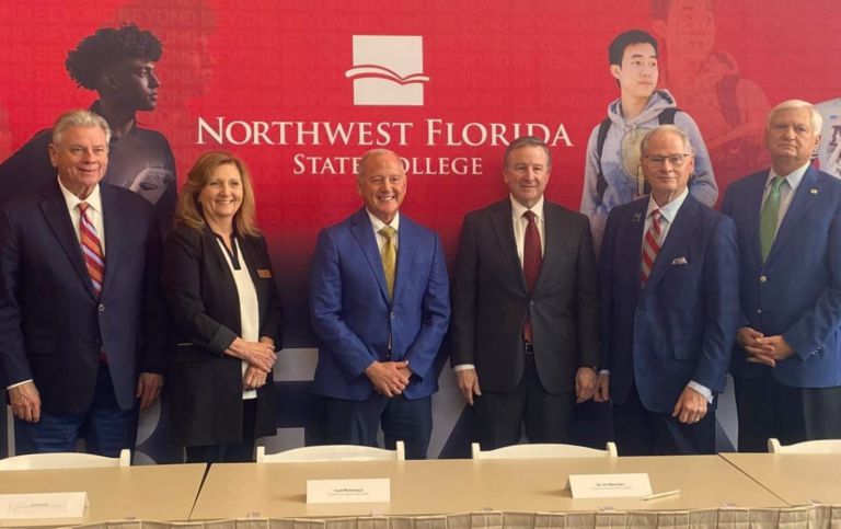 Group photo at Northwest Florida State College signing event with PSC and state college leaders.