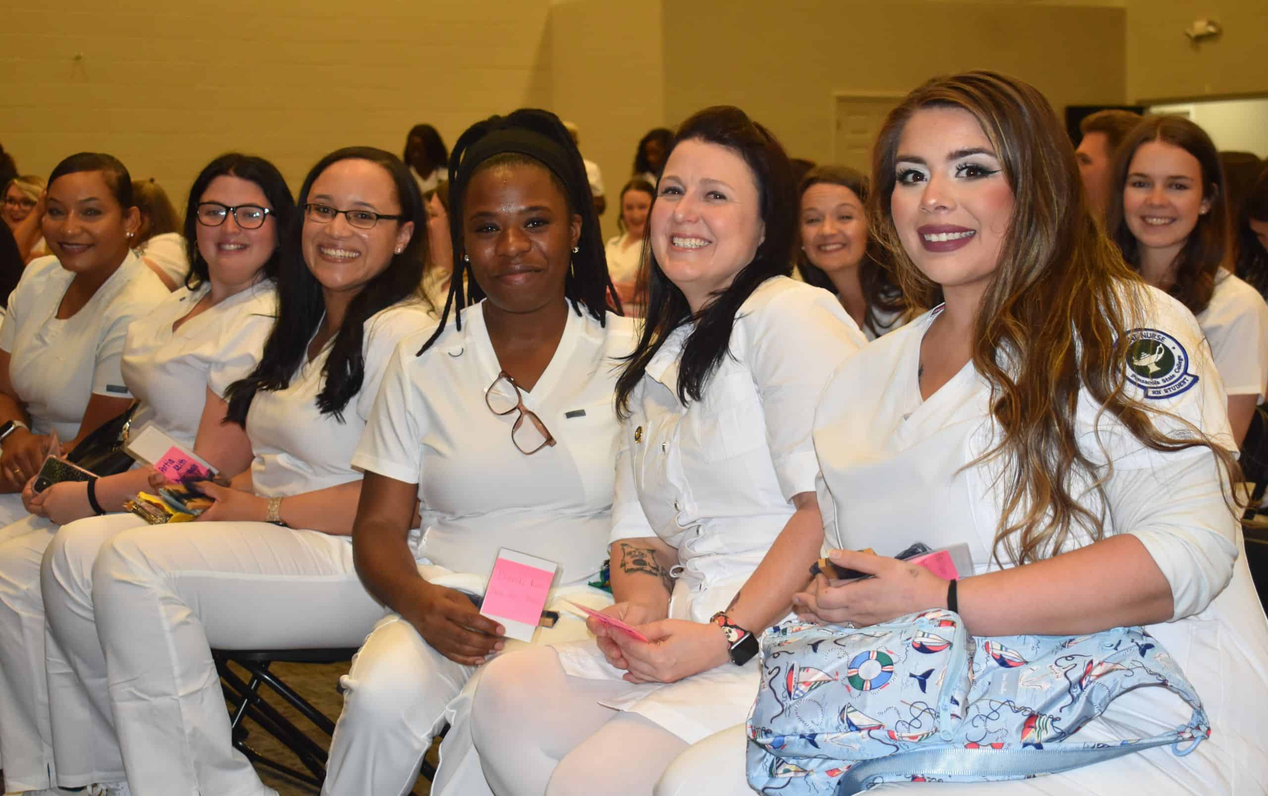 Nursing students at Pensacola State College celebrating pinning ceremony for nursing graduates.